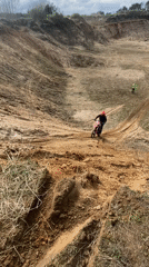 Dirt biker struggles through muddy quarry terrain in Belarus
