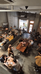 Industrial cafe scene in Đà Nẵng with laptops and meals