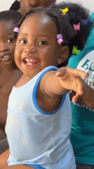 Toddler plays at home while water collected in Jos