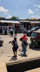 Women distribute flyers on busy Aba street amid traffic