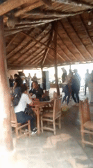 Open-air thatched restaurant captured in Juan Griego evening scene