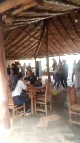 Open-air thatched restaurant captured in Juan Griego evening scene
