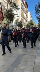 Religious procession with marching band parades through Madrid streets