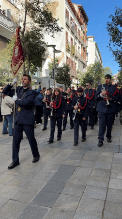 Religious procession with marching band parades through Madrid streets