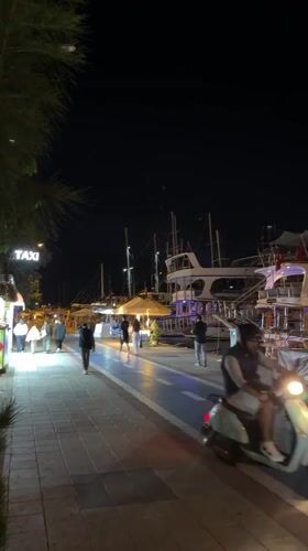Evening harbor life continues in Turkish resort town