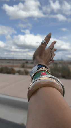 Person extends hand skyward from moving vehicle in Palm Springs