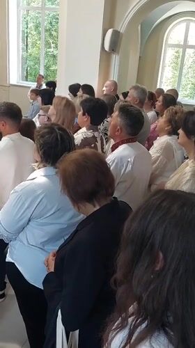 Diverse crowd gathers in apparent church setting in Ternopil