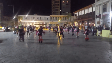 Costumed dancers perform nighttime plaza show in Iquique