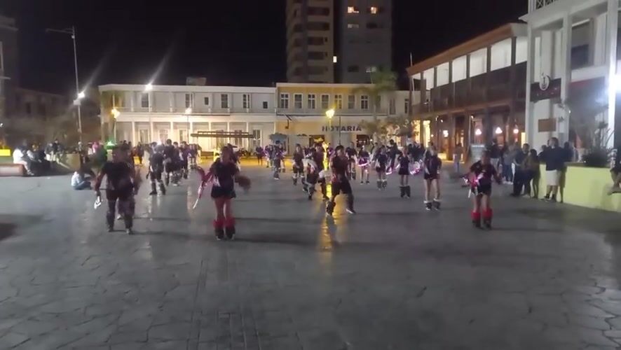 Costumed dancers perform nighttime plaza show in Iquique