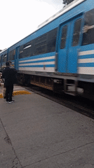 Train crosses road near pedestrians in Buenos Aires