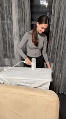 Woman does evening ironing, steaming in Sofia apartment