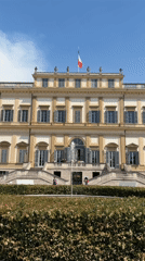 Multi-story building with Italian flag observed in Monza park