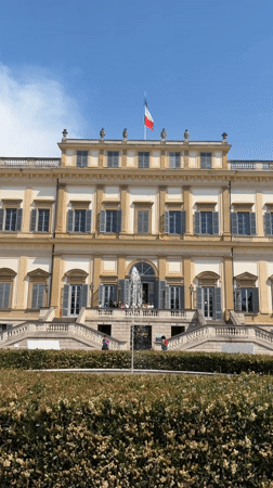 Multi-story building with Italian flag observed in Monza park