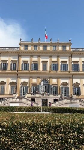 Multi-story building with Italian flag observed in Monza park