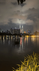 Kuala Lumpur skyline captured reflecting in lake at night