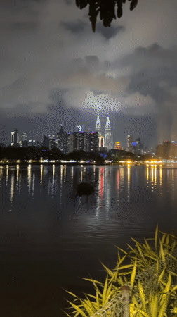 Kuala Lumpur skyline captured reflecting in lake at night