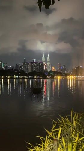 Kuala Lumpur skyline captured reflecting in lake at night