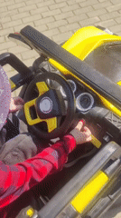 Child plays with toy vehicle in Mytishchi morning