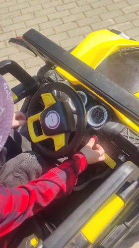 Child plays with toy vehicle in Mytishchi morning