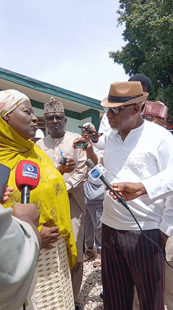 Woman holds outdoor press briefing in Ungwan Liman, Nigeria
