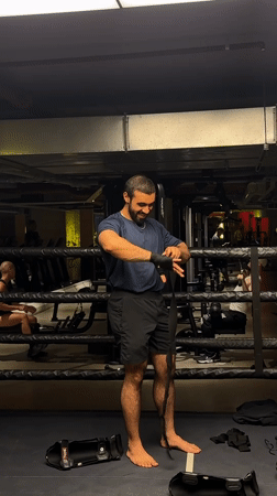 Boxer prepares equipment for training session in London gym