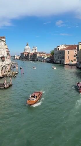 Venice tourists enjoy canal boats and pizza dining