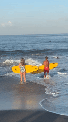 Beach day with surfboards and paddleboarding in North Kuta