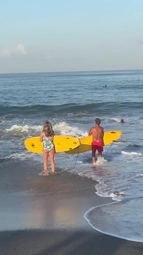 Beach day with surfboards and paddleboarding in North Kuta