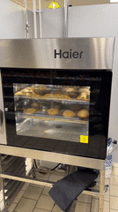 Commercial oven loaded with bread loaves mid-bake in Yekaterinburg