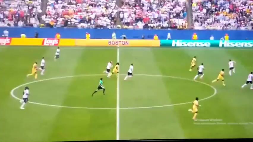 This is a video clip of a soccer match. The scene is a bright, outdoor soccer field with a large crowd in the background. The players are wearing white and yellow uniforms. The game appears to be in progress, with players running and kicking the ball. The lighting suggests it is daytime. There is no visible text related to the match itself, but there is a watermark that reads "Aктивация Windows" in the lower right corner of the screen, indicating the recording software being used. The overall mood is energetic and competitive.