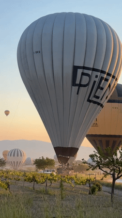 Hot air balloons rise over Cappadocia at sunrise