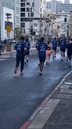 Marathon runners race through wet Tel Aviv streets Friday morning