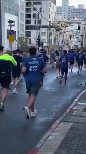 Marathon runners race through wet Tel Aviv streets Friday morning