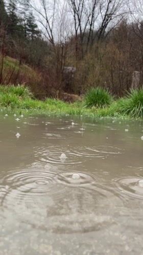 Rainfall creates ripples in puddle in Smolyan, Bulgaria