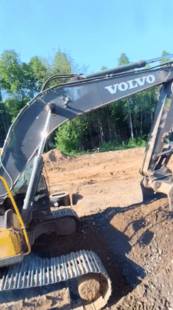 Excavator performs earthwork at Oktyabrsky construction site