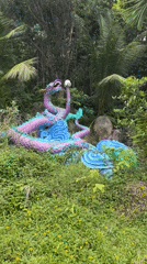 Visitors explore nature park with waterfalls, dragon statues in Thailand