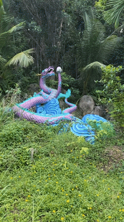 Visitors explore nature park with waterfalls, dragon statues in Thailand