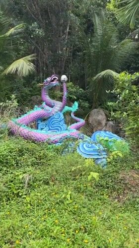 Visitors explore nature park with waterfalls, dragon statues in Thailand