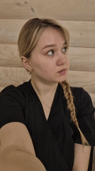 Woman recorded in wooden sauna interior in Chaikovsky, Russia