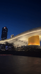Red-lit skyscrapers illuminate Futian District plaza at night