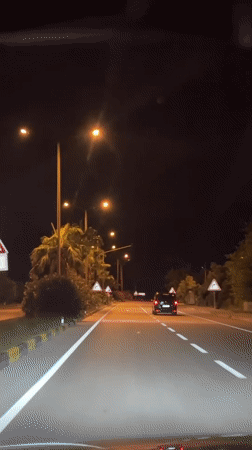 Nighttime traffic observed on lit road in Fethiye, Turkey