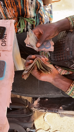Morning street life and political billboard maintenance in Gwong, Nigeria