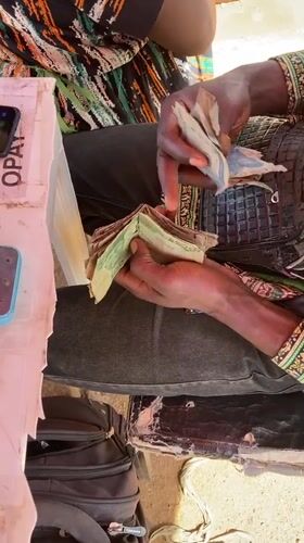 Morning street life and political billboard maintenance in Gwong, Nigeria