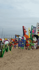 Valencia beach hosts art displays and volleyball under cloudy skies