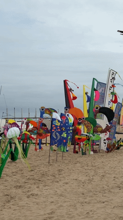 Valencia beach hosts art displays and volleyball under cloudy skies