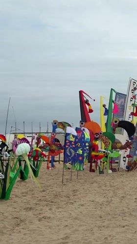 Valencia beach hosts art displays and volleyball under cloudy skies