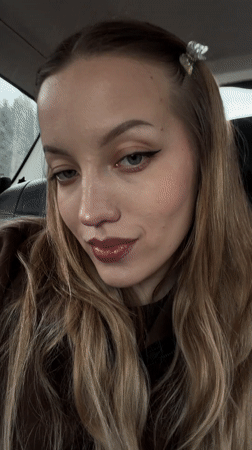 Woman photographed smiling in car backseat in Yamuga, Russia