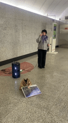 Woman sings in subway station as passengers wait
