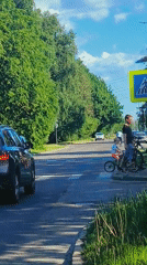 Woman takes car selfie on sunny Riga street