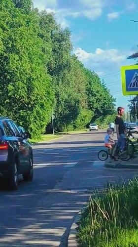 Woman takes car selfie on sunny Riga street